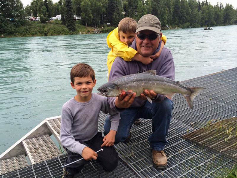 Dad and sons with a salmon