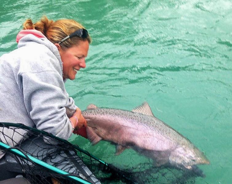 Alaska fishing guide Mindy Payne releasing a Kenai king salmon