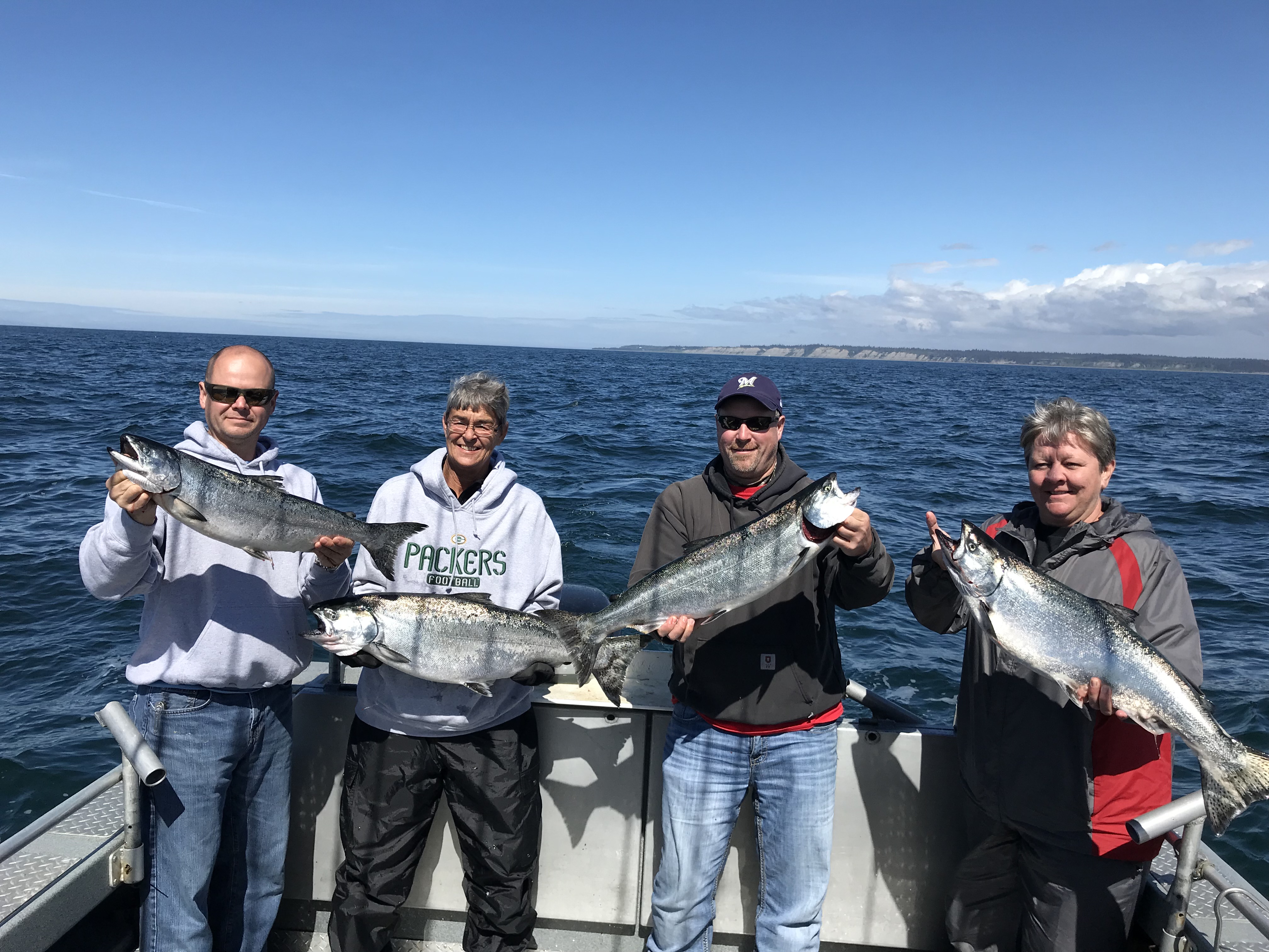 Group of saltwater salmon fishermen on the back of the boat with their limit.